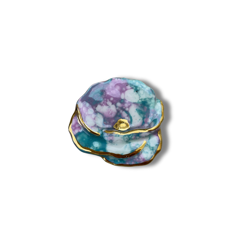 Multicolor brooch with gold on a white background