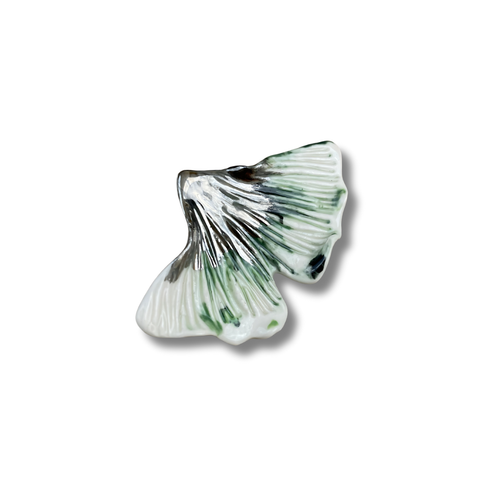 Brooch with a ginkgo leaf on a white background