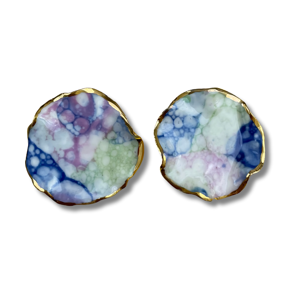 Pair of earrings with a multicolored marbled design and a gold border on a white background