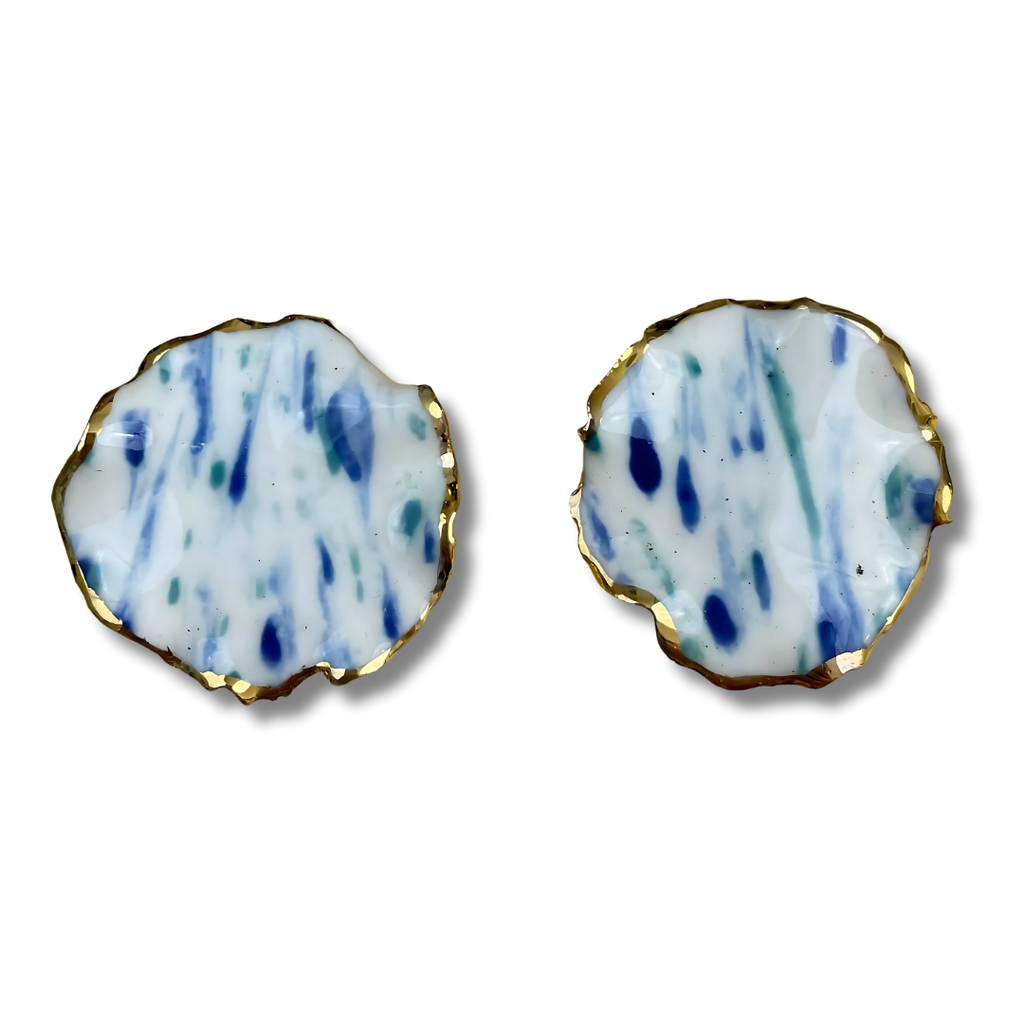 Pair of round earrings with a blue and white pattern on a white background