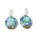 Pair of earrings with blue, green, and gold marbled design on a white background