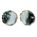 Pair of earrings with a black, white, and gold design on a white background