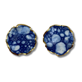 Pair of round earrings with a blue and white marbled design and a gold border against a white background