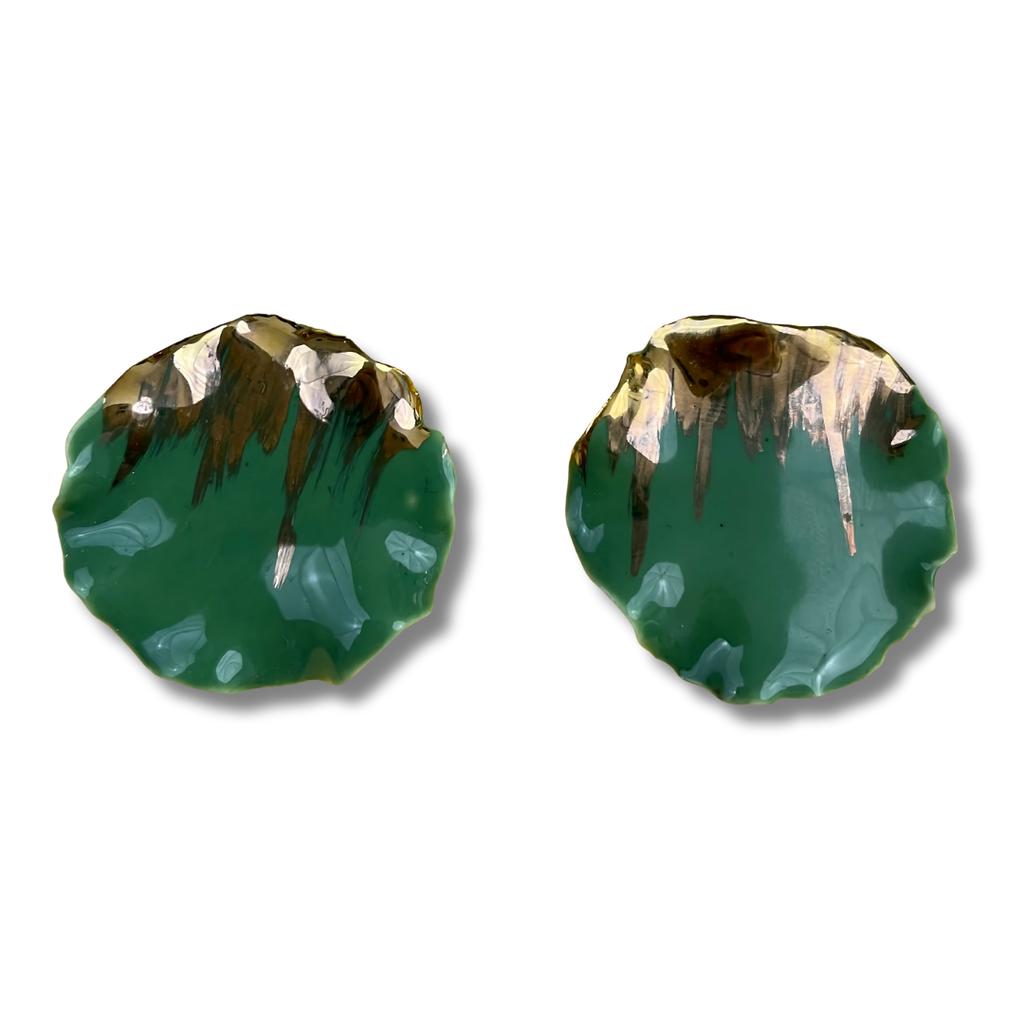 Pair of green earrings with gold accents on a white background