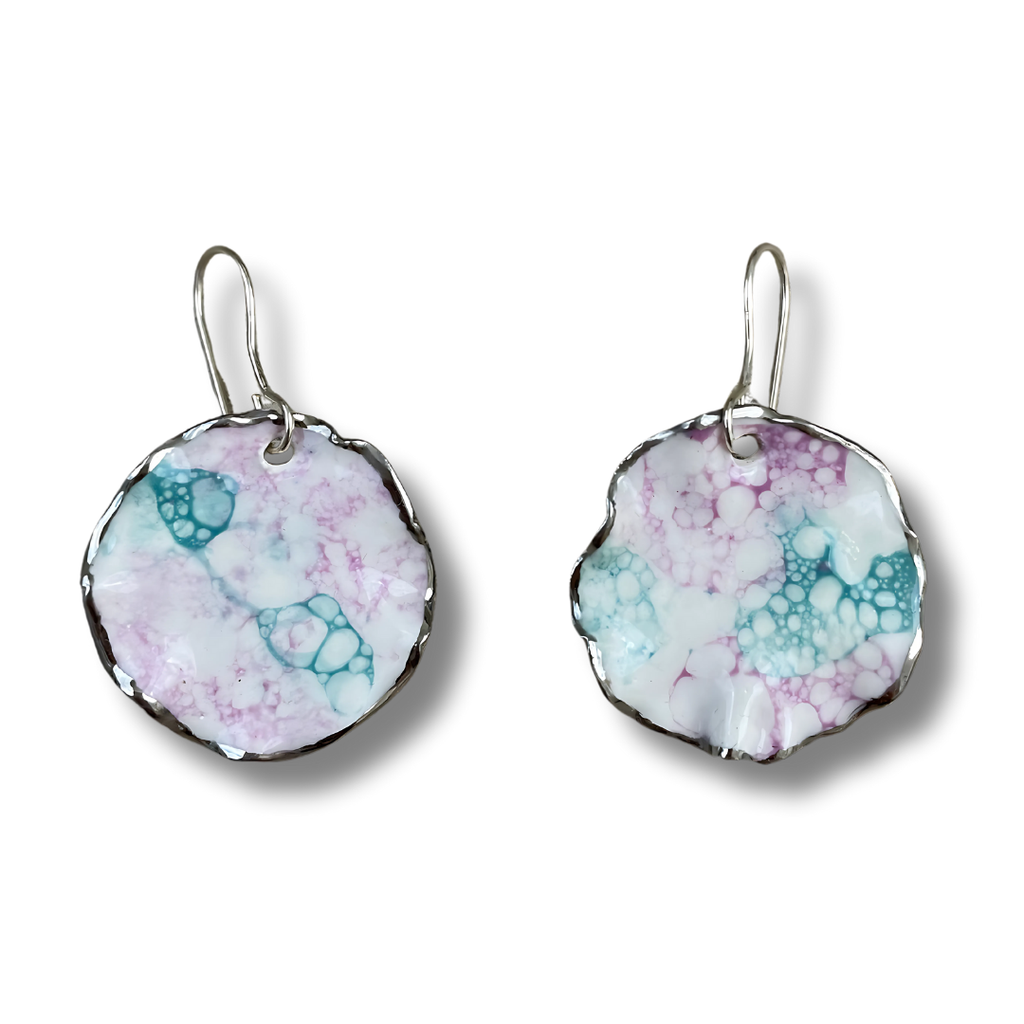 Pair of turquoise and purple earrings with a marbled design on a white background