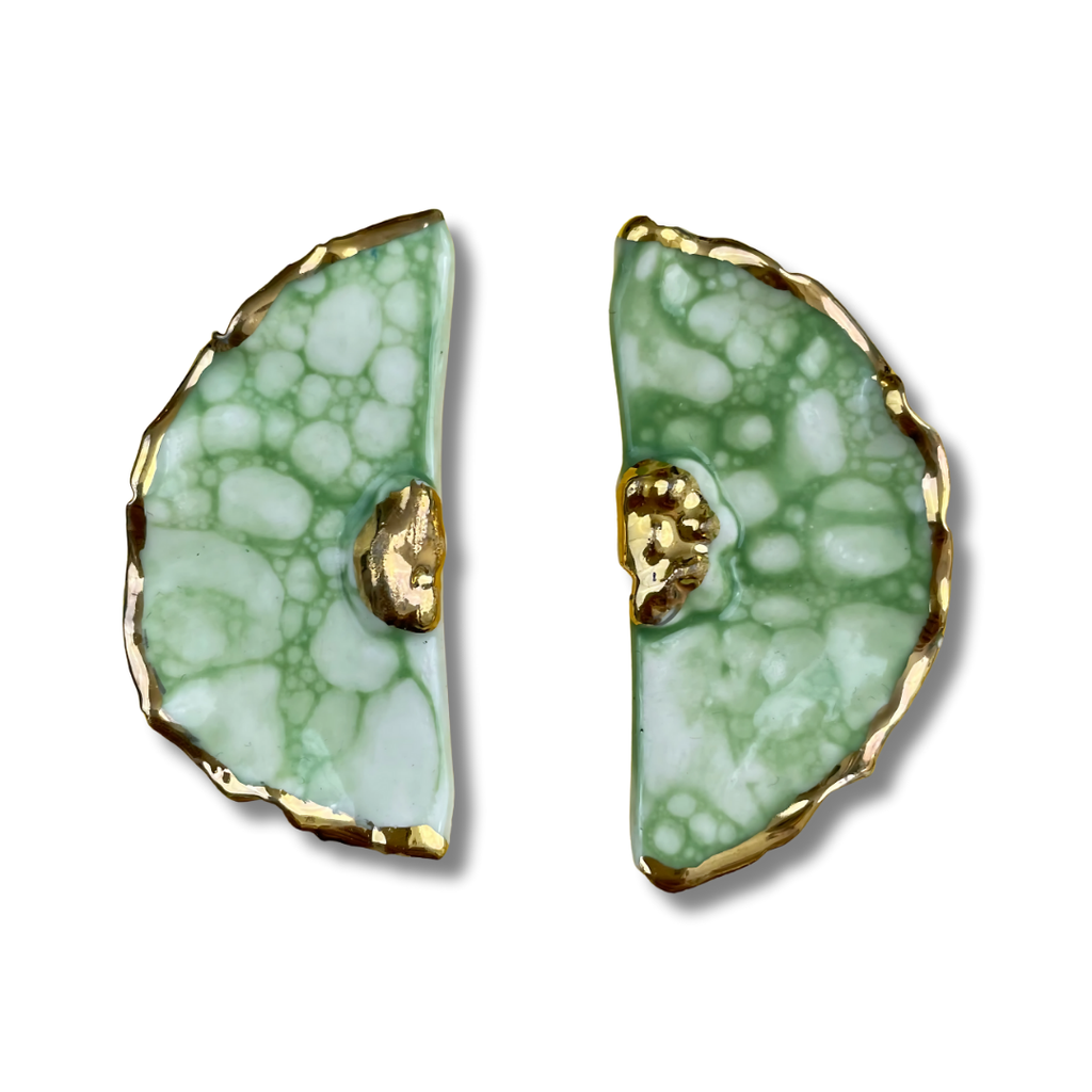 Pair of green porcelain earrings with gold accents on a white background
