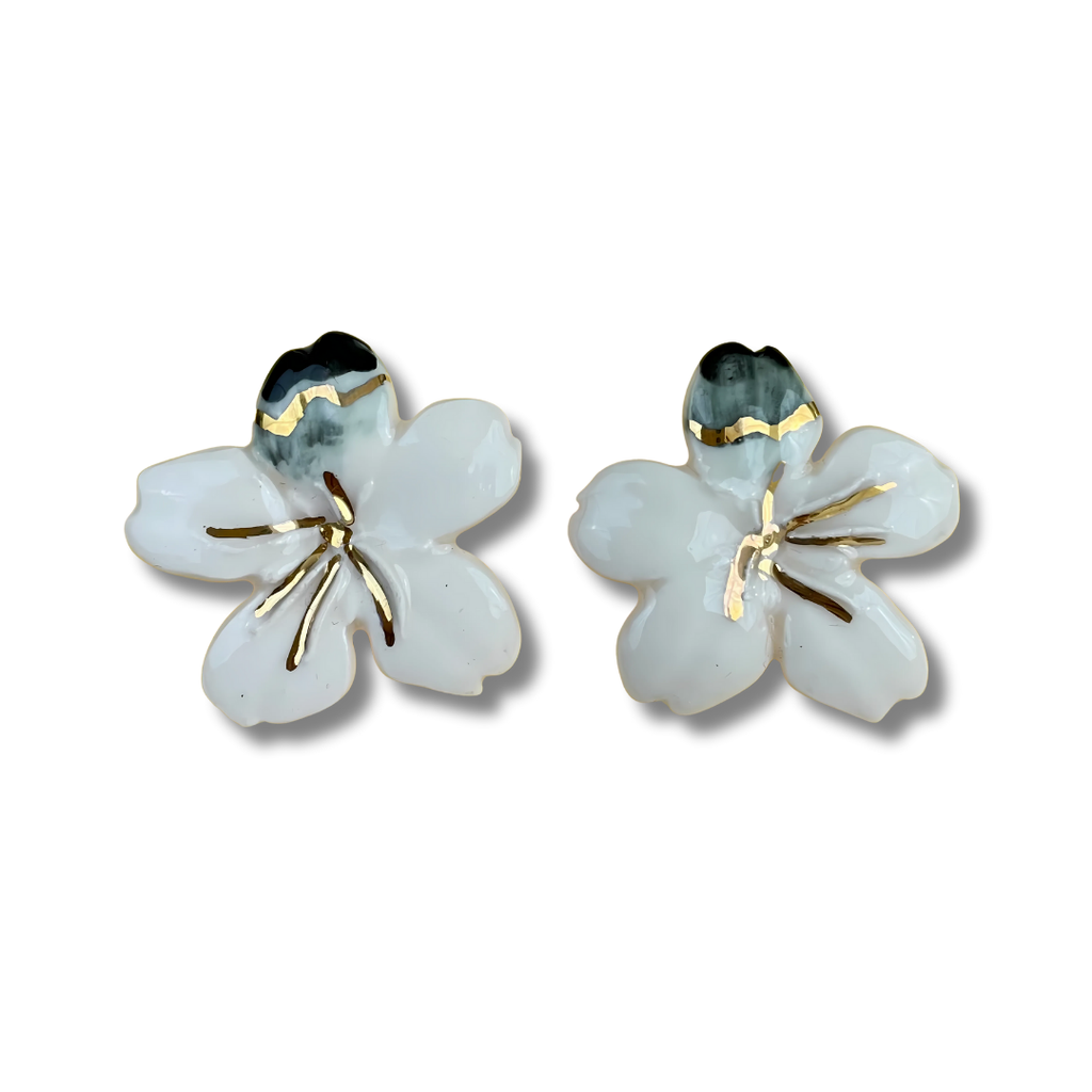 Pair of floral earrings with gold accents on a white background