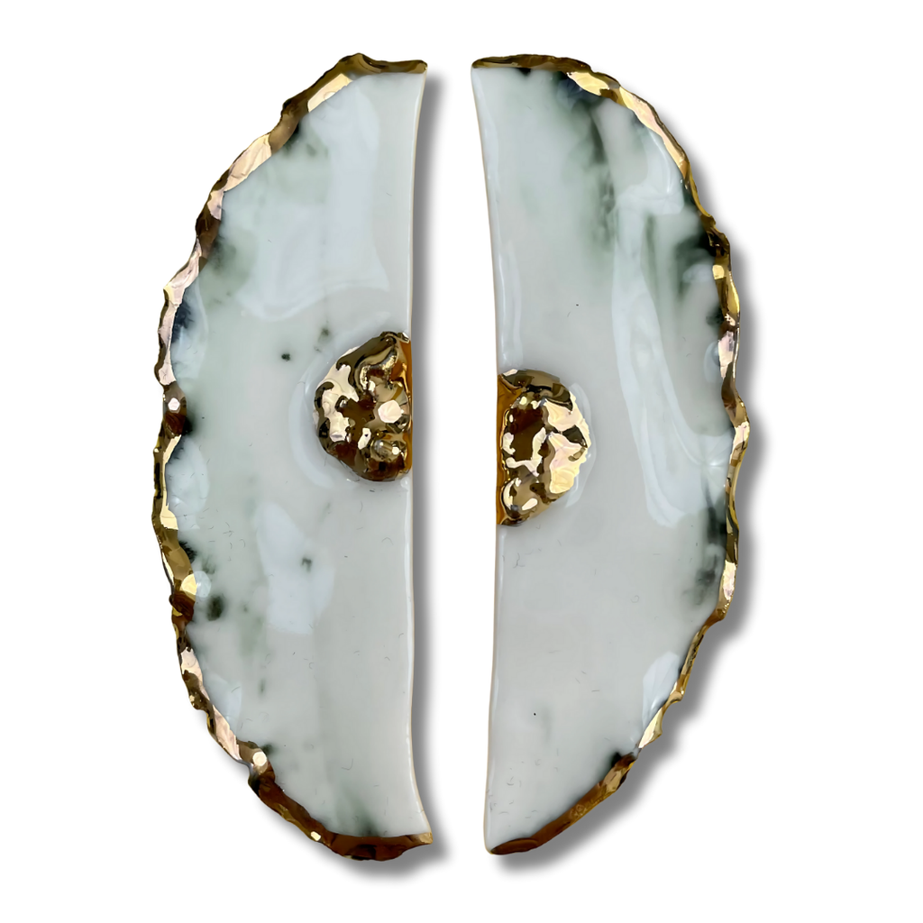 Flower-shaped earrings with gold accents on a white background.