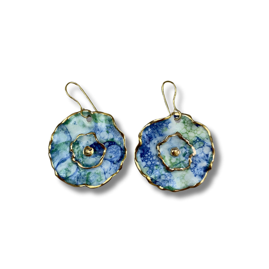 Pair of floral earrings with a blue and green pattern and gold details on a white background