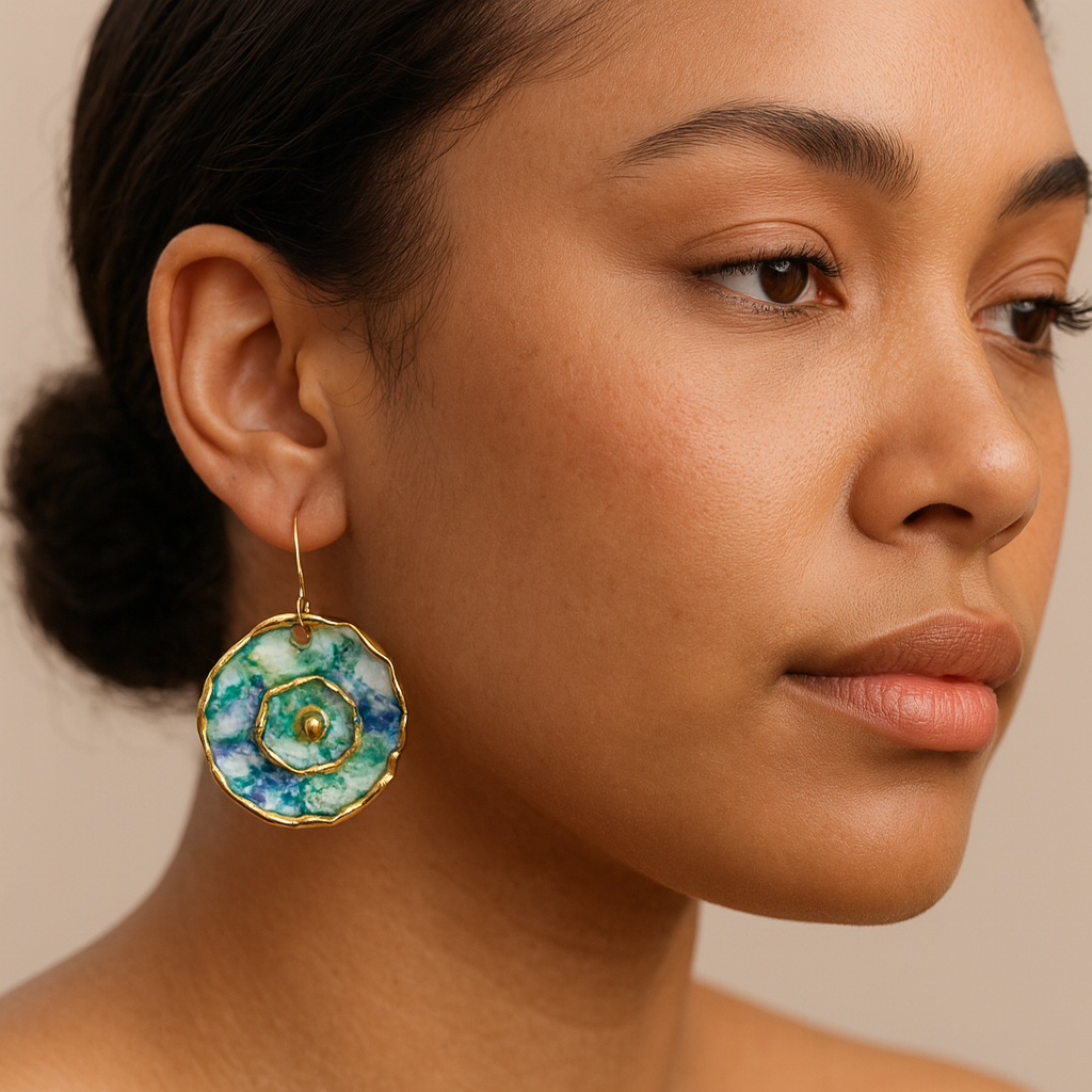 Close-up of a woman wearing a green and blue floral earring with a beige background