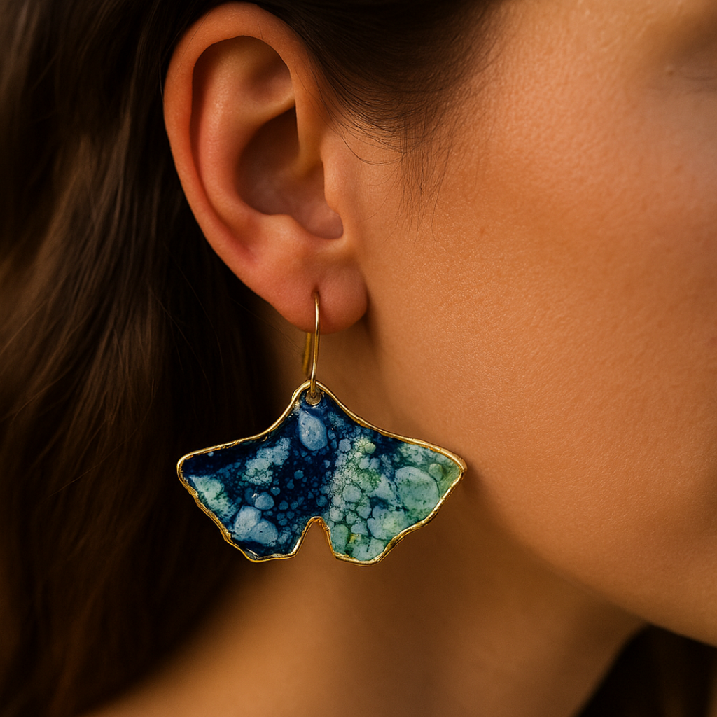 Close-up of a person wearing a blue, green, and gold earring.
