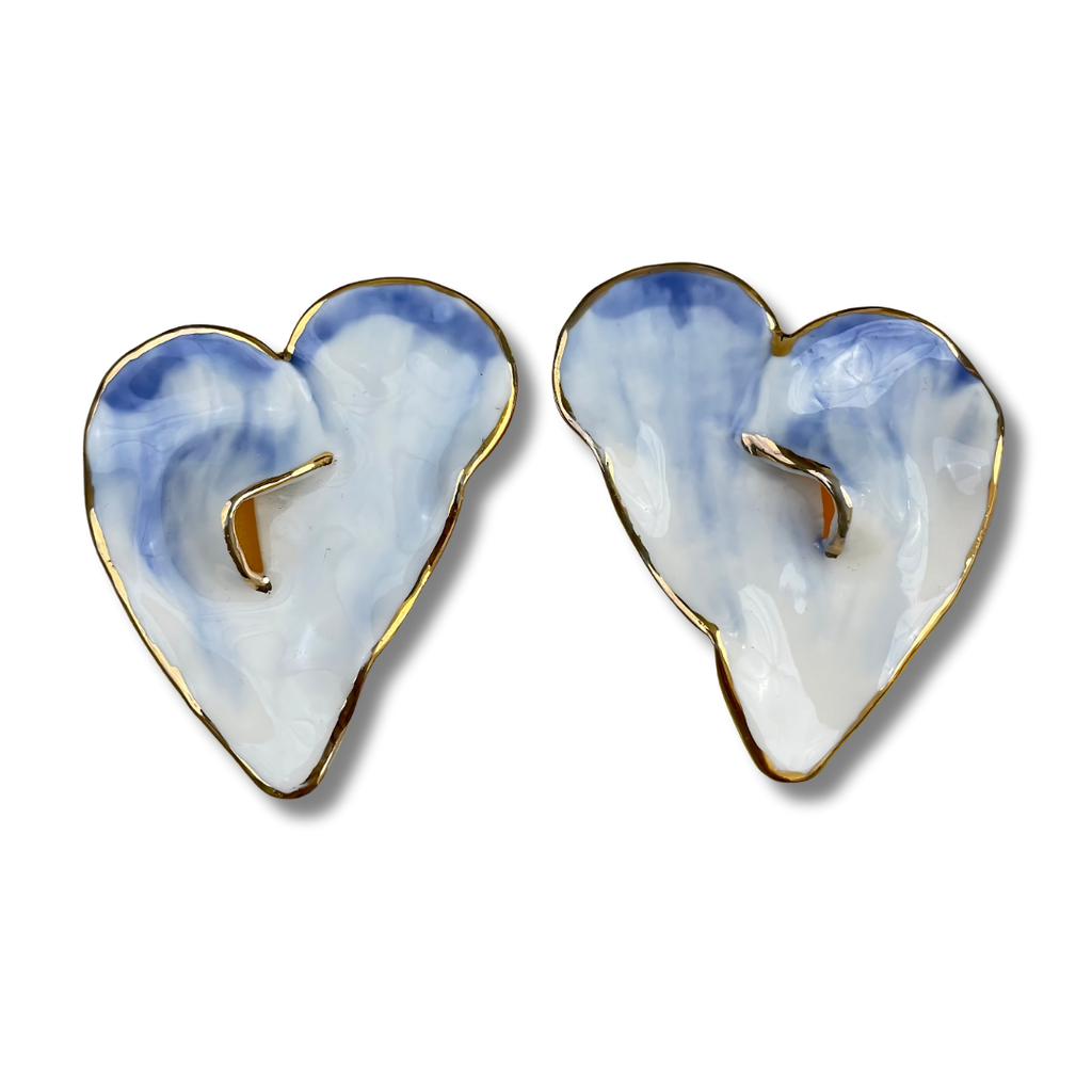 Heart-shaped earrings with a blue and white design on a white background